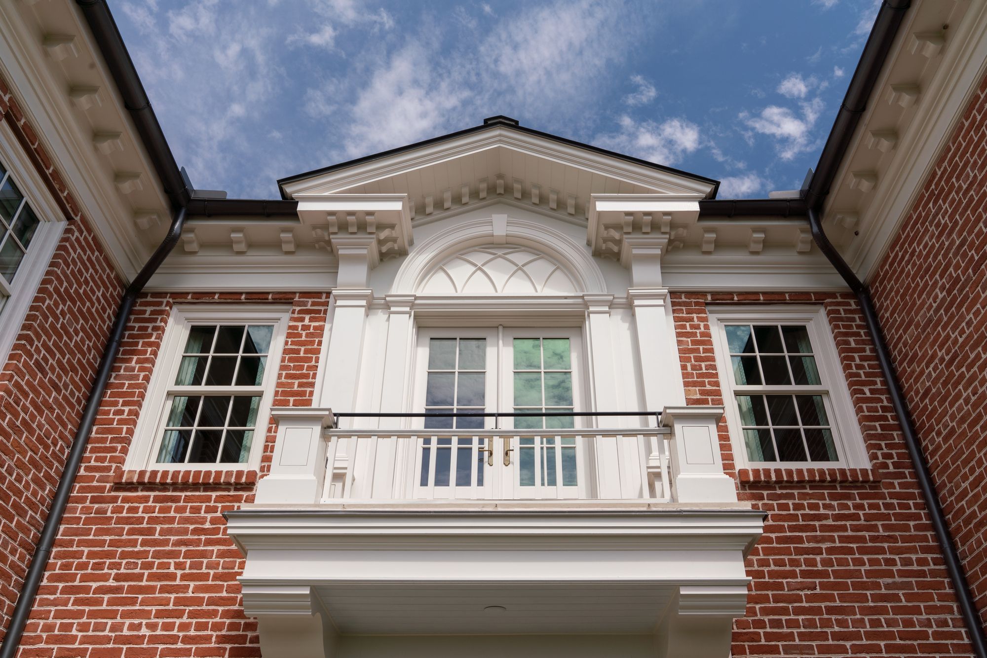 Pedimented bay with a balcony above the garden door