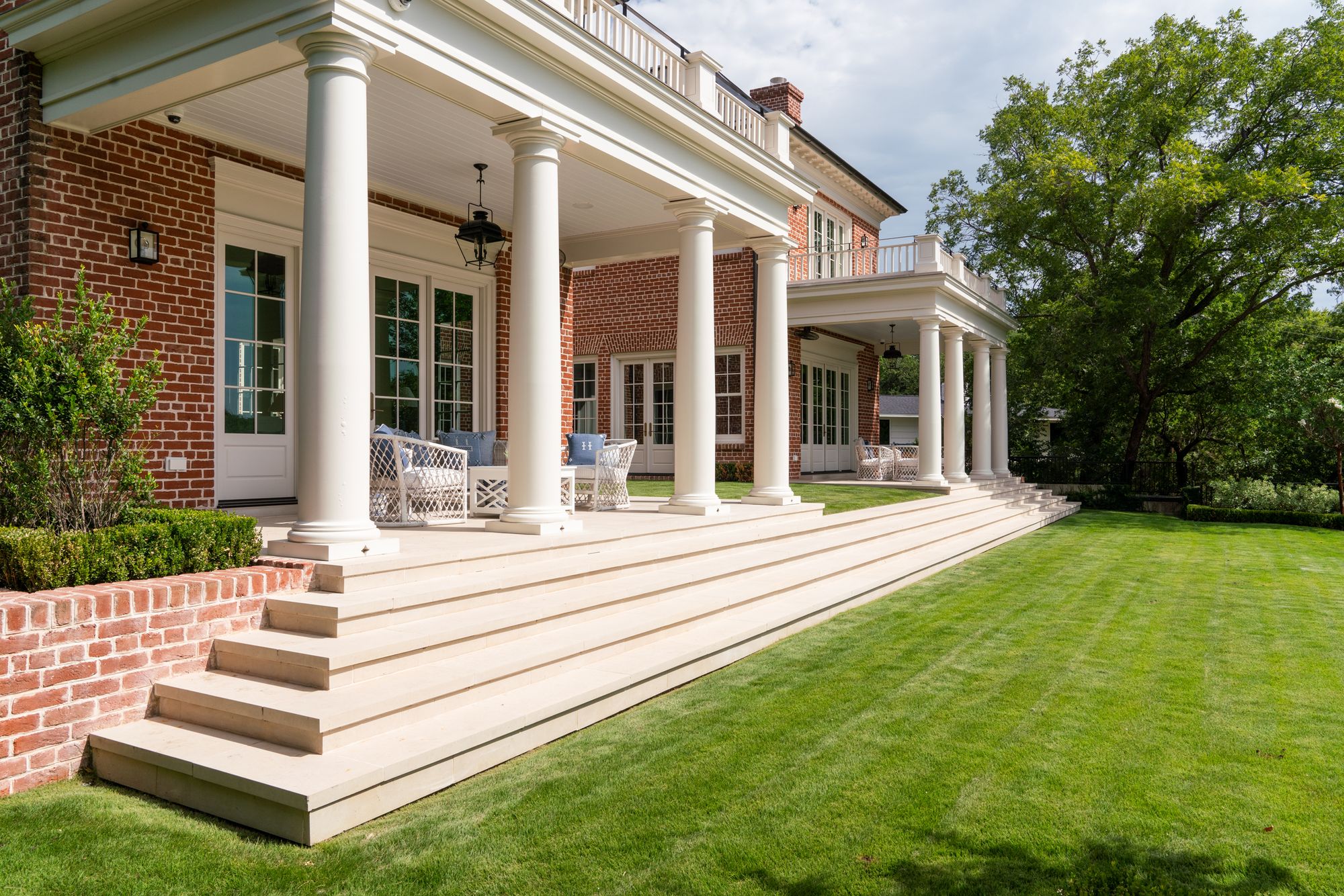 Columned porch and wide limestone steps to the lawn