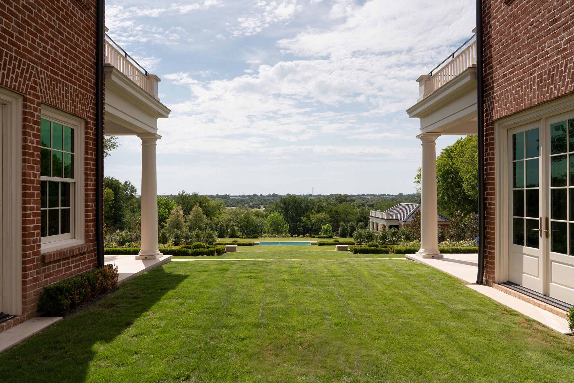 Lawn running between two porches toward the view