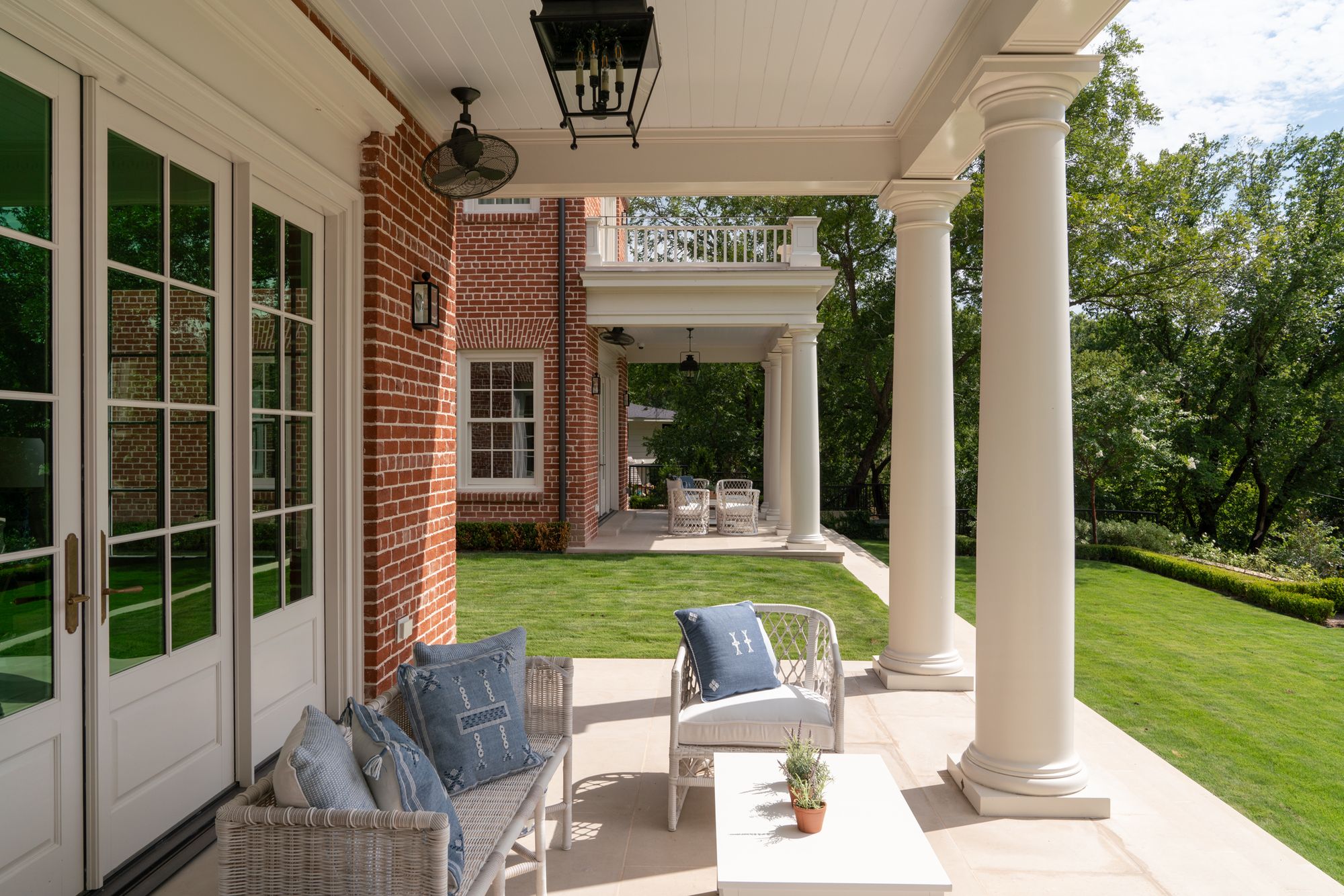 Porch seating between white columns