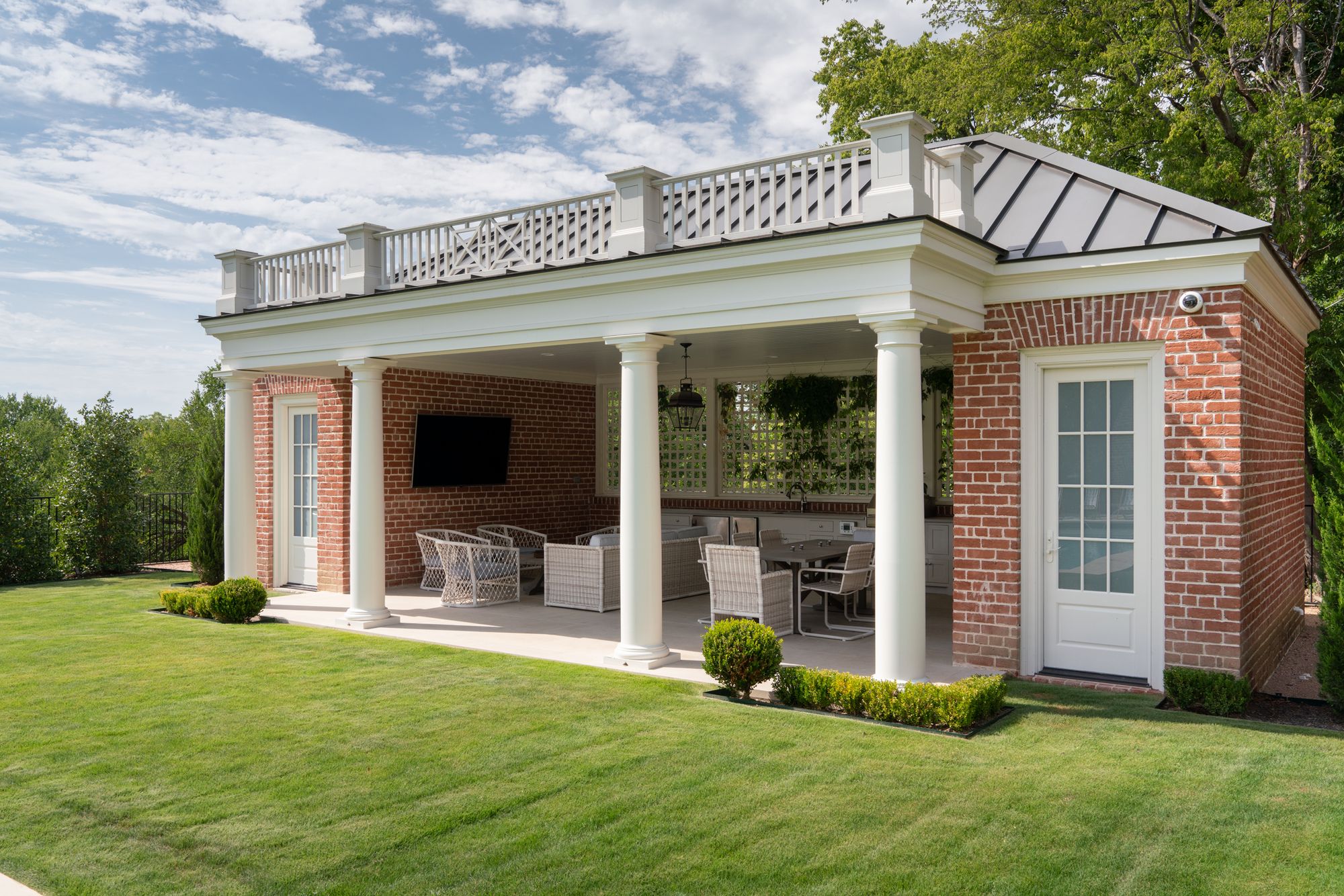 Brick pool house with a balustraded roof