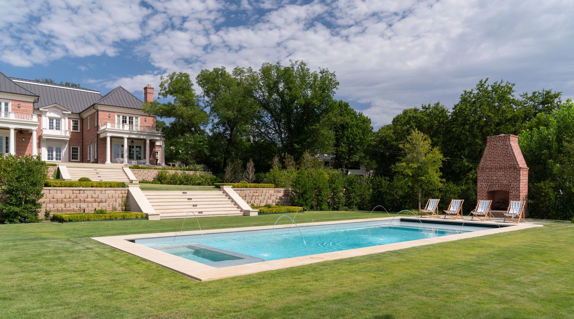 Pool and terraced lawn below the house