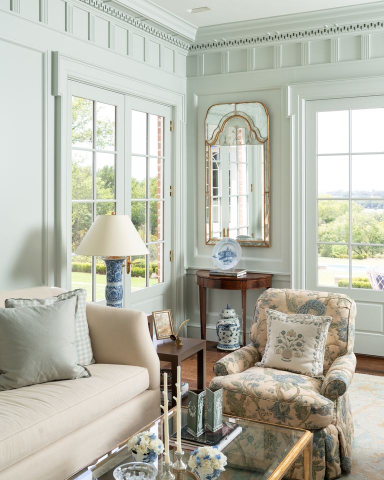 Sitting room with tall windows and a mirror