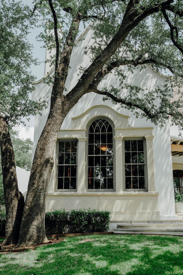 Arched window bay framed in cut stone