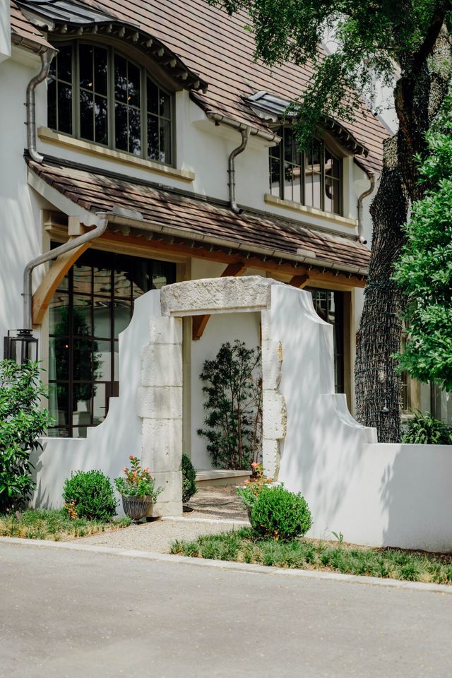 Garden gate in a curved limewashed wall