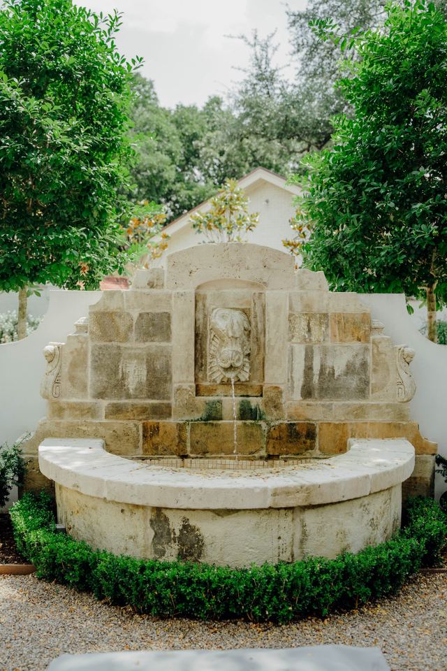 Carved stone fountain at the end of the garden court