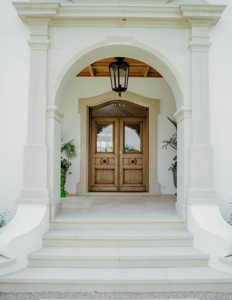Stone archway framing the front door and lantern