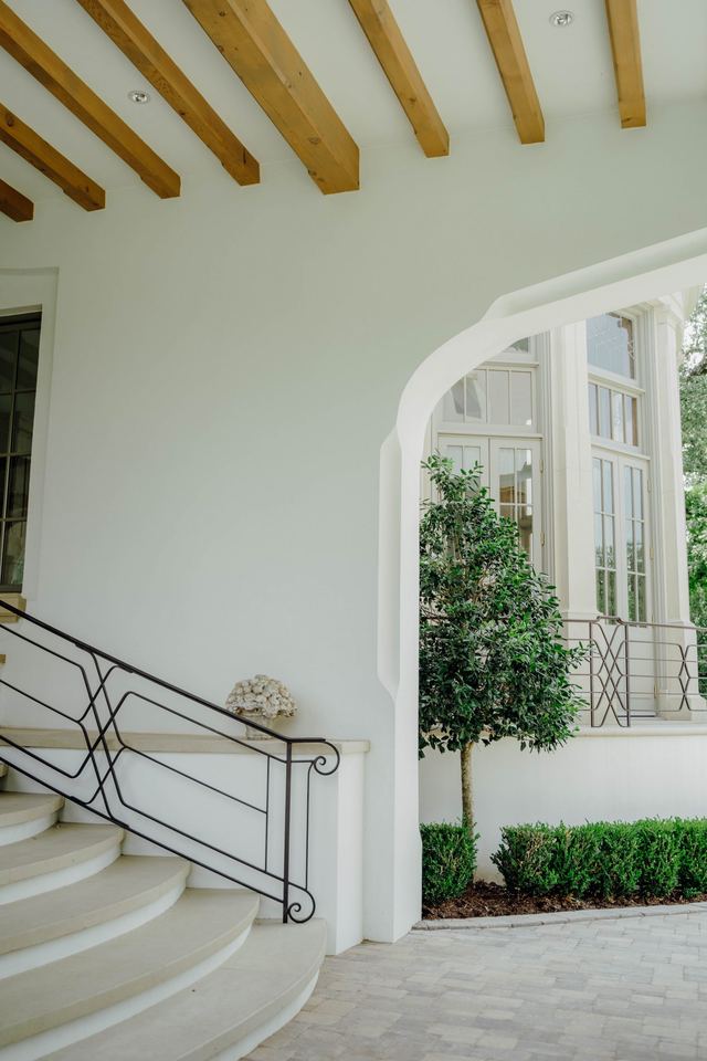 Beamed porch ceiling and curved stair rail