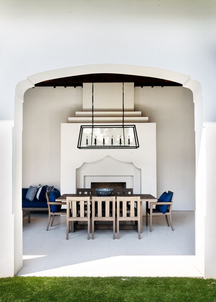 Covered outdoor room with fireplace and dining table