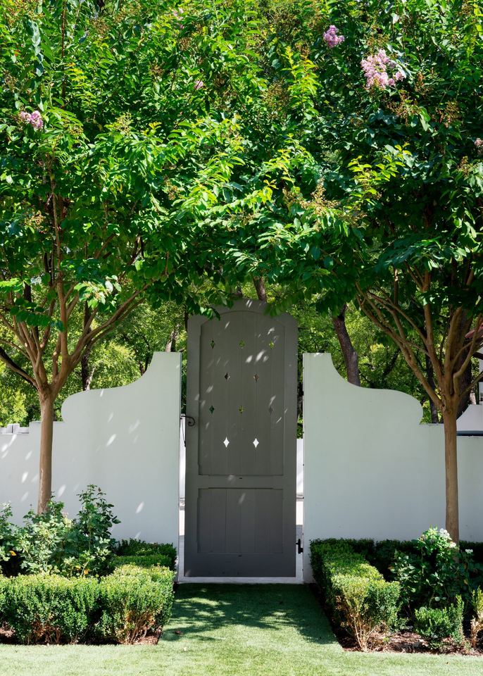 Garden gate in a curved stucco wall