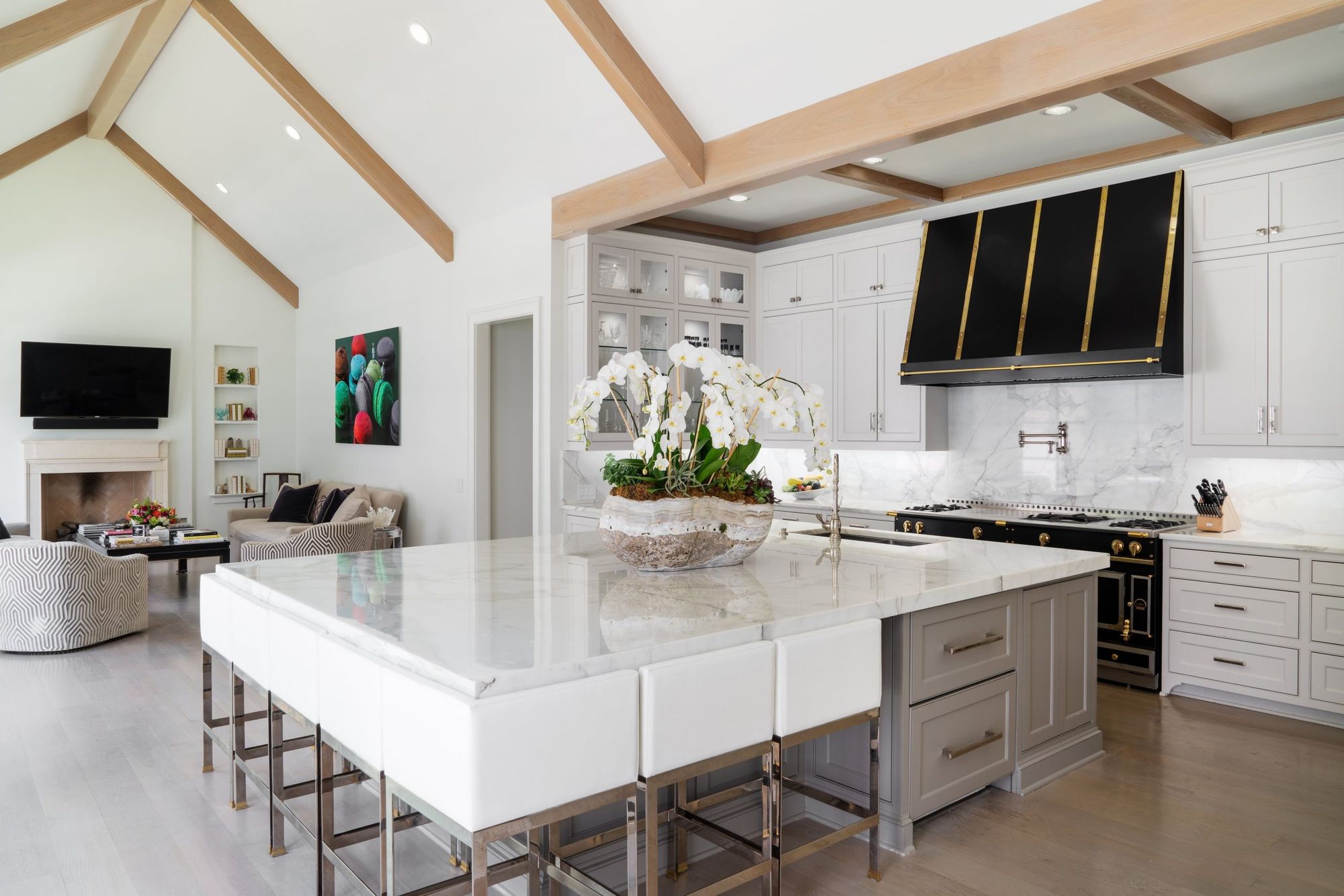Kitchen and living room under white oak trusses