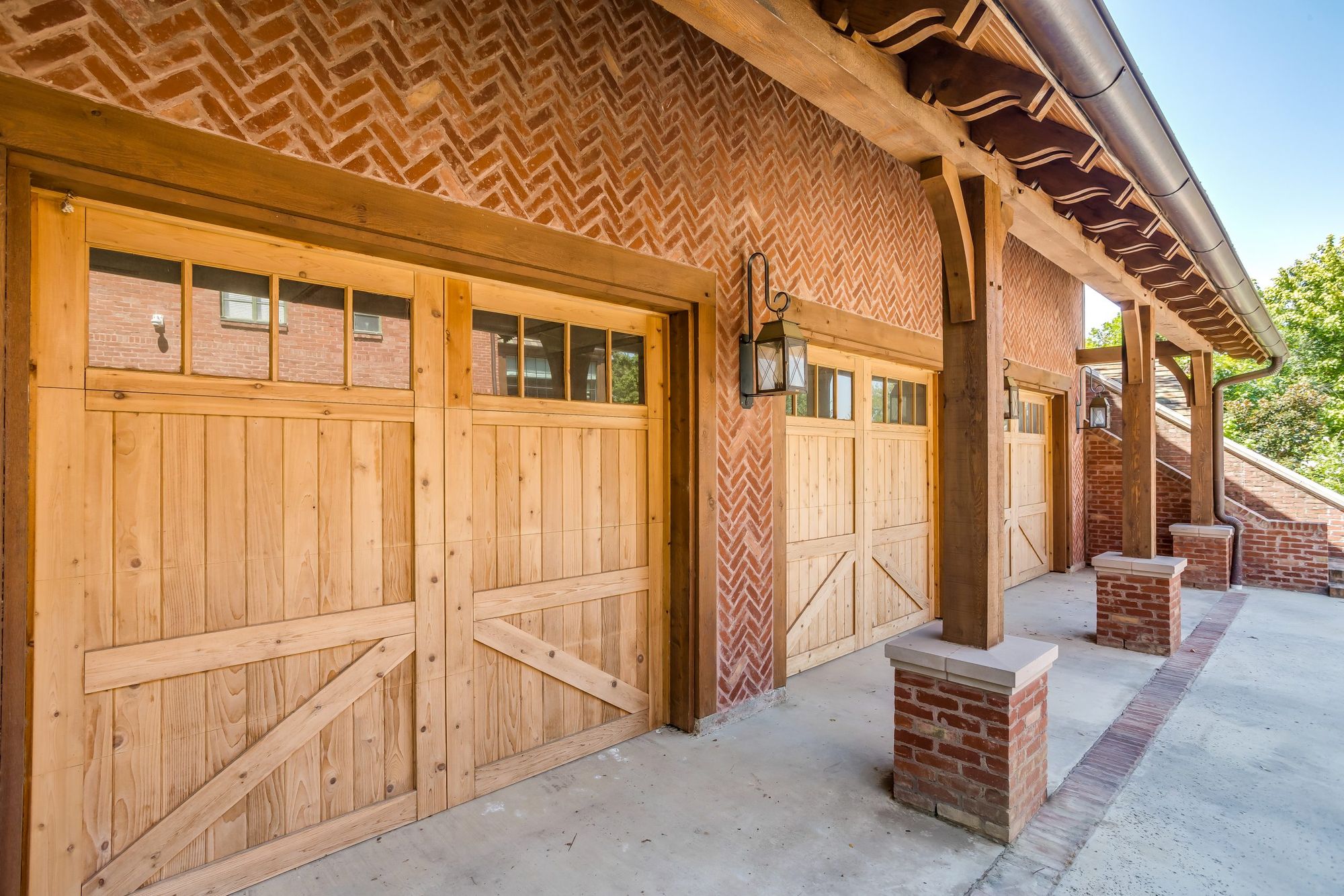 Cedar garage doors set in herringbone brick