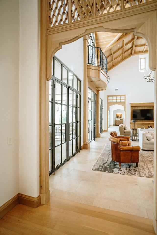 Gallery with steel windows and a carved wood screen