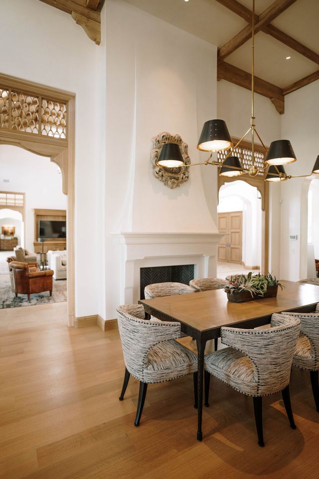 Dining room by the fireplace under beamed ceiling