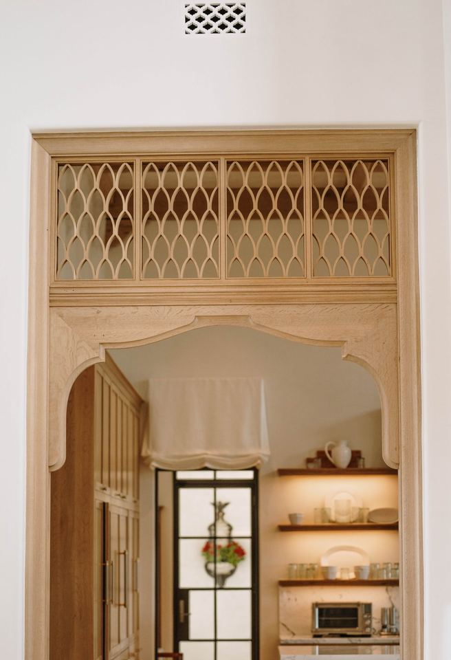 Carved wood arch with lattice transom